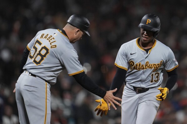 Pittsburgh Pirates' Ke'Bryan Hayes, right, celebrates with third base coach and field coordinator Mike Rabelo, left, after hitting a solo home run against the San Francisco Giants during the 10th inning of a baseball game Saturday, April 27, 2024, in San Francisco. (AP Photo/Godofredo A. Vásquez)