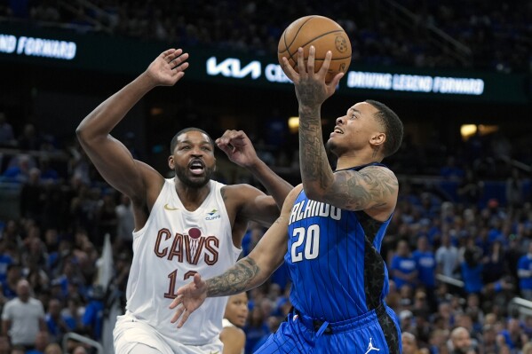 Orlando Magic guard Markelle Fultz (20) makes a basket ahead of Cleveland Cavaliers center Tristan Thompson during the second half of Game 4 of an NBA basketball first-round playoff series, Saturday, April 27, 2024, in Orlando, Fla. (AP Photo/John Raoux)