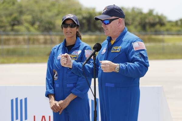 NASA astronauts Butch Wilmore, right, and Suni Williams speak to the media after they arrived at the Kennedy Space Center, Thursday, April 25, 2024, in Cape Canaveral, Fla. The two test pilots will launch aboard Boeing's Starliner capsule atop an Atlas rocket to the International Space Station, scheduled for liftoff on May 6, 2024. (AP Photo/Terry Renna)