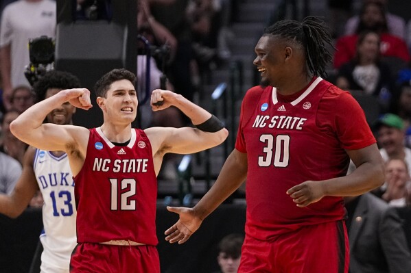 North Carolina State's Michael O'Connell (12) reacts after a basket by DJ Burns Jr. (30) against Duke during the second half of an Elite Eight college basketball game in the NCAA Tournament in Dallas, Sunday, March 31, 2024. (AP Photo/Tony Gutierrez)