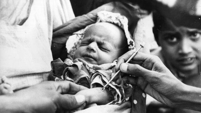 a baby in Pakistan receiving a smallpox vaccine