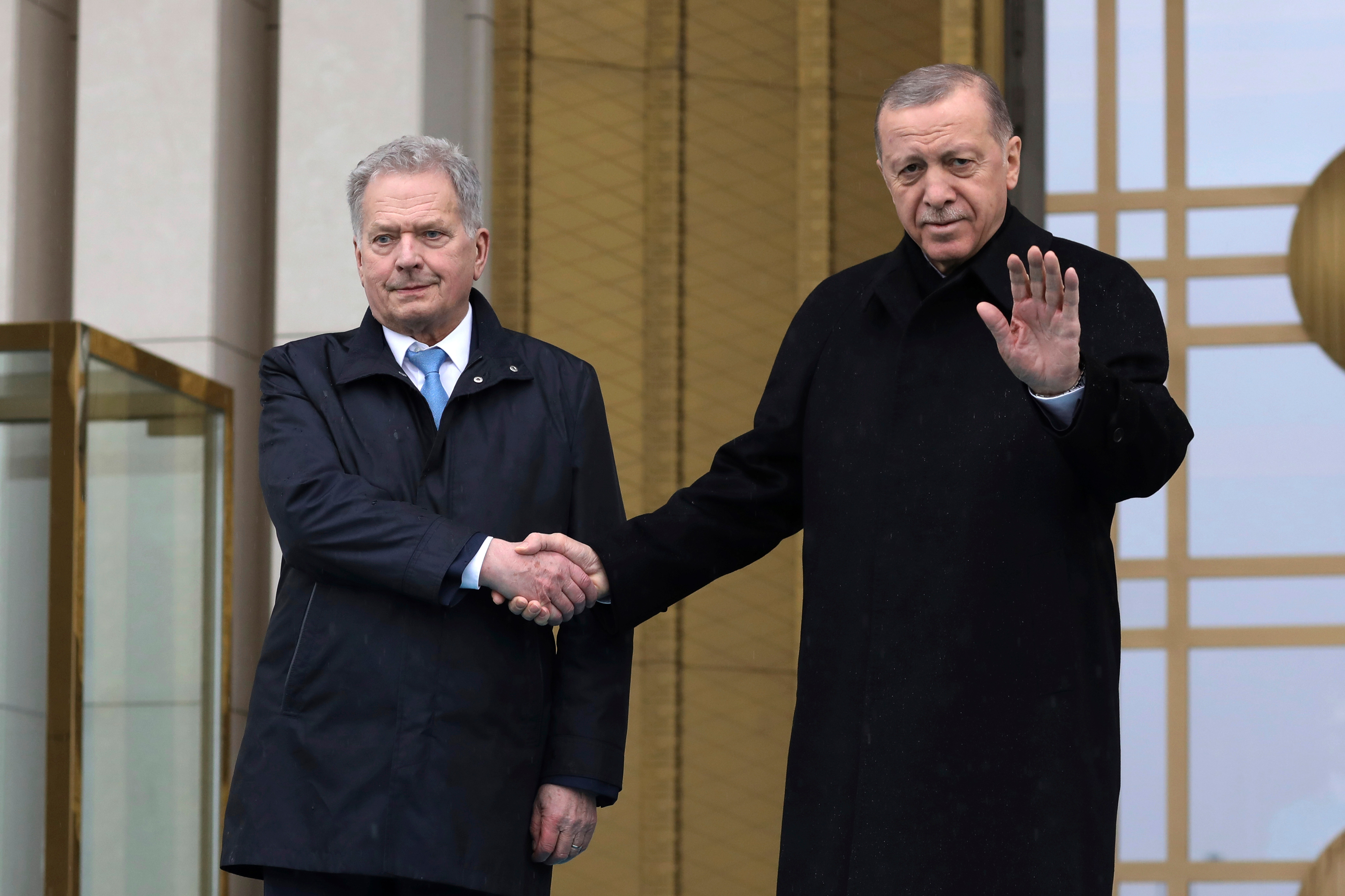 Turkish President Recep Tayyip Erdogan, right, and Finland's President Sauli Niinistö shake hands during a welcome ceremony at the presidential palace in Ankara, Turkey, on March 17.