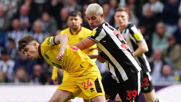 Oliver Arblaster and Bruno Guimaraes battle for the ball