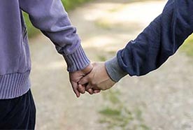 Two people holding hands