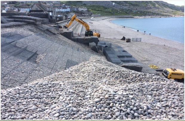Photo shows work being carried out to the gabion 'castle' and crest of the shingle bank at Chesil beach in Portland, Dorset
