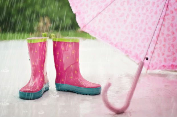 Child's pink wellies and umbrella