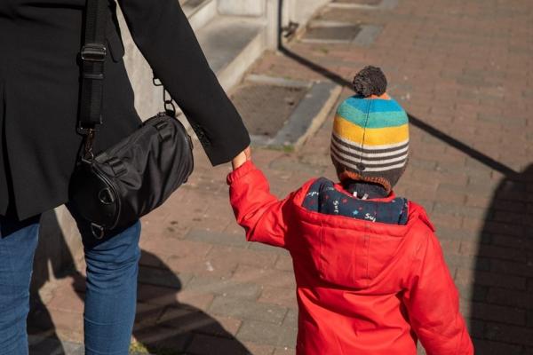 woman and a child walking on the street