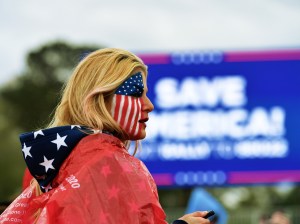 A woman in American flag face paint attends a Save America rally