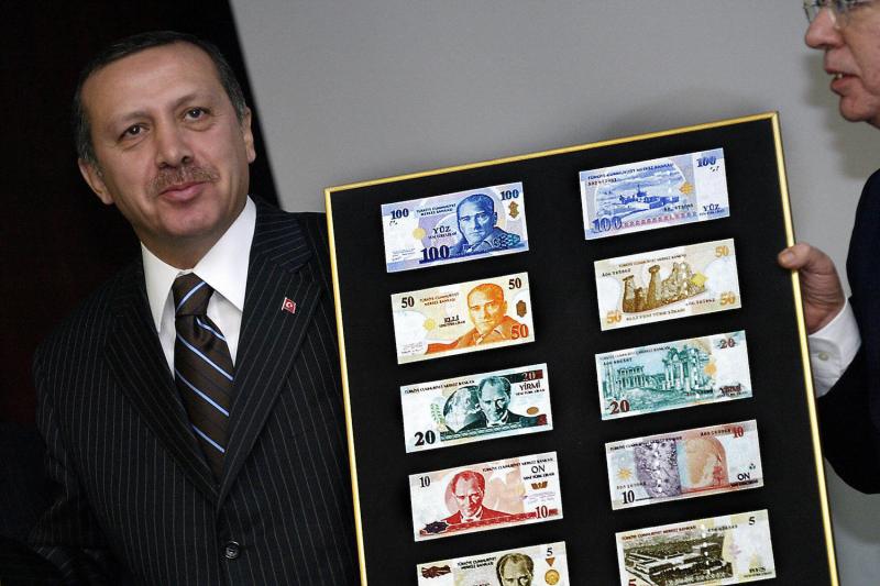 Turkish Prime Minister Recep Tayyip Erdogan displays the new Turkish lira in Ankara on October 25, 2004. (Tarik Tinazay/AFP/Getty Images)