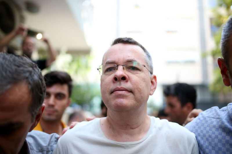 The Rev. Andrew Brunson, escorted by Turkish plainclothes police officers, arrives at his house in Izmir on July 25. (Stringer/AFP/Getty Images)