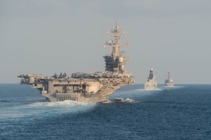 A U.S. aircraft carrier and destroyers in the Strait of Hormuz on Nov. 19, 2019.