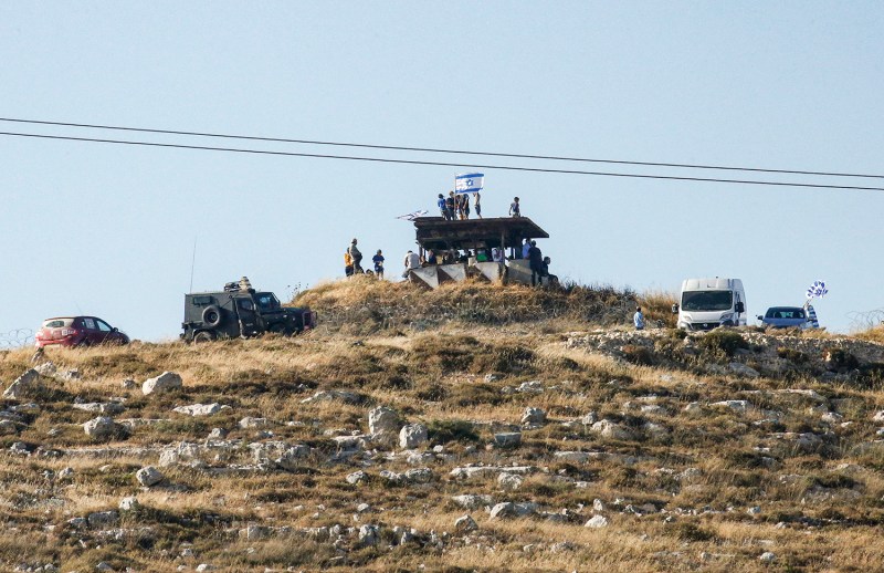 Israeli settlers gather on a hill next to the Palestinian town of Halhul, in the occupied West Bank, on June 30 as they attend a rally against U.S. President Donald Trump's peace plan.