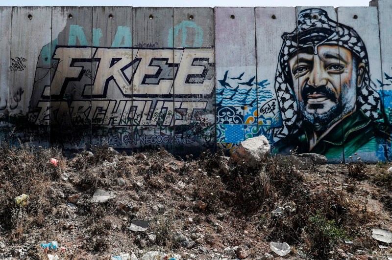 A mural on Israel's controversial separation wall between Jerusalem and Ramallah depicts the former chairman of the Palestine Liberation Organization, Yasser Arafat, in 2017.