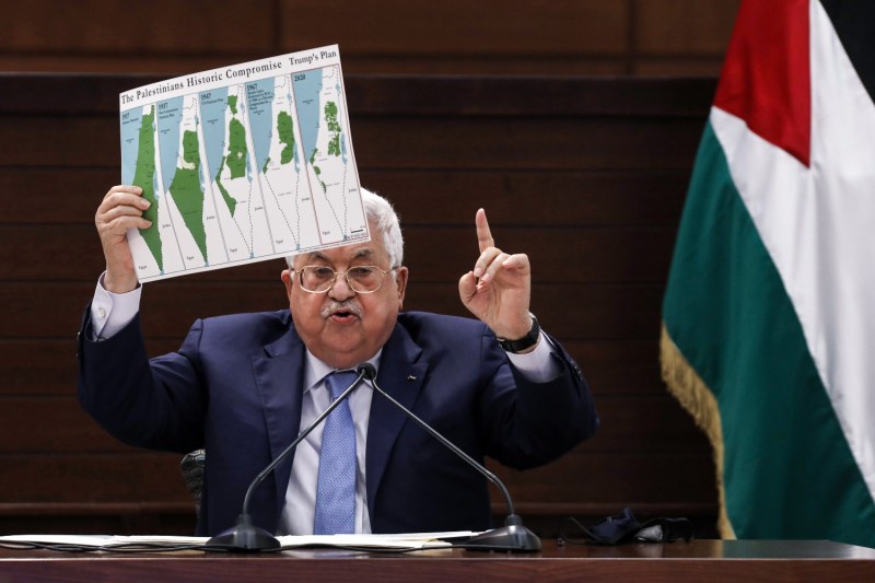 Palestinian Authority President Mahmoud Abbas displays a map of historic Palestine and Palestinian land loss since 1937 in Ramallah, West Bank, on Sept. 3, 2020.