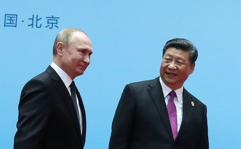 Chinese President Xi Jinping and Russian President Vladimir Putin smile during the Belt and Road Forum.