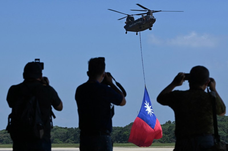 A US-made CH-47 helicopter flies an 18-meter by 12-meter national flag at a military base in Taoyuan on September 28, 2021.