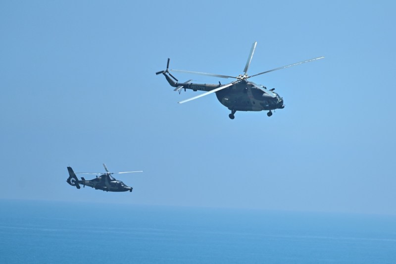 Chinese military helicopters fly past Pingtan island.