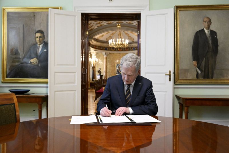 Finnish President Sauli Niinisto signs Finland's national NATO legislation in Helsinki.