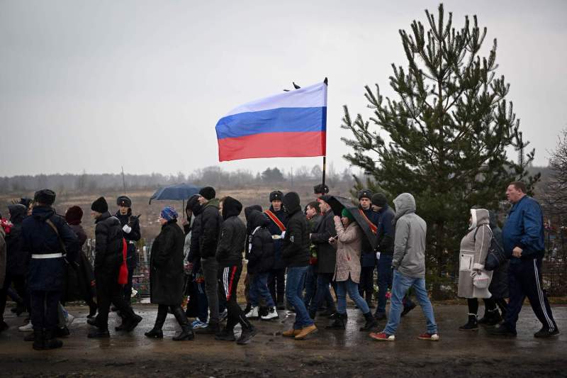 A picture shows a funeral ceremony for a fallen Russian soldier at a cemetery in Bogoroditsk, Russia.