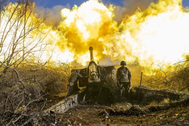 A Ukrainian artillery soldier fires a howitzer toward Russian positions near Bakhmut, Ukraine.