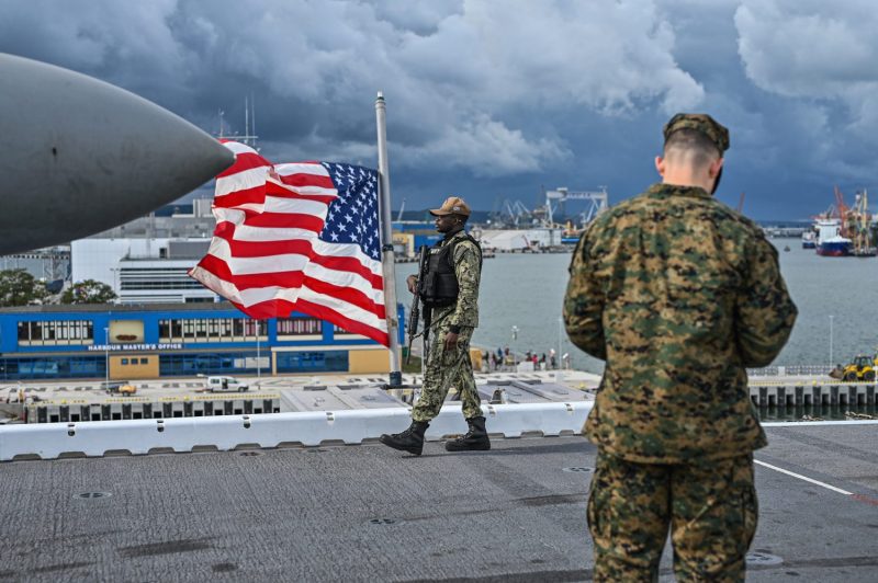 A U.S. Navy officer patrols the flight deck of the USS Kearsarge, an amphibious assault ship docked in Gdynia, Poland, on Sept. 17, 2022.