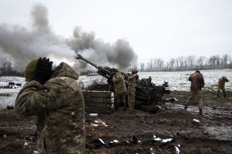 Ukrainian soldiers fire a M777 howitzer toward Russian positions on the front line in eastern Ukraine.