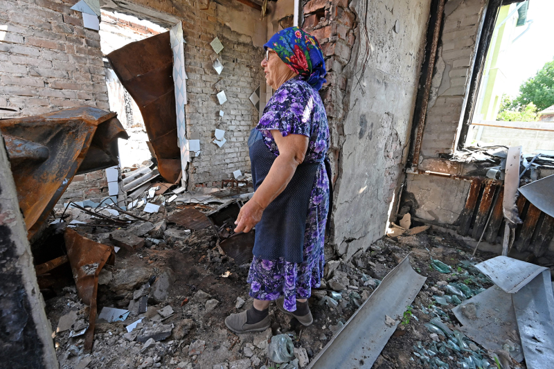 Liubov, 70, looks at the remains of her house in the Ukrainian village of Rus'ka Lozova.
