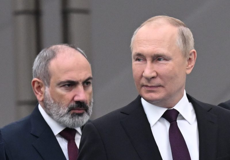 Armenian Prime Minister Nikol Pashinyan (left) and Russian President Vladimir Putin arrive at the Commonwealth of Independent States summit in Astana, Kazakhstan.