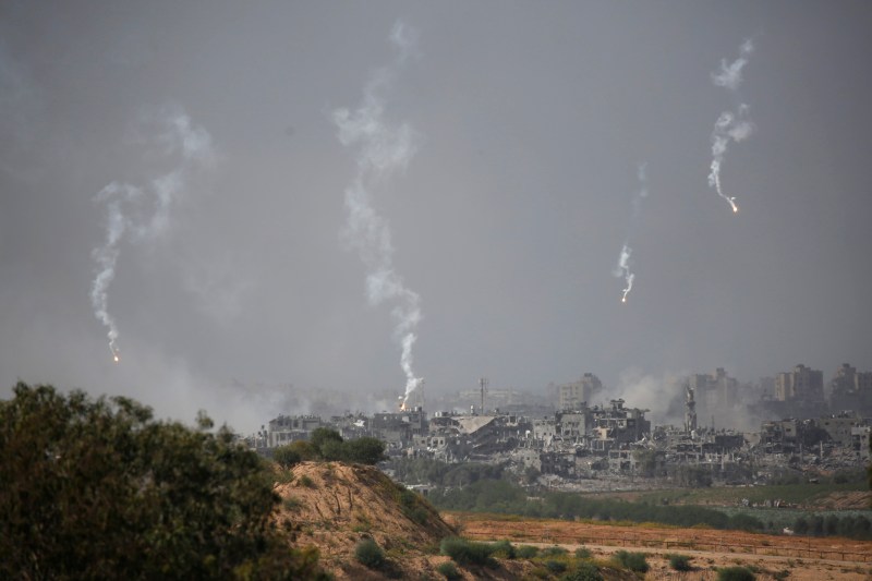 Seen from Sderot, Israel, flares fired from Israeli artillery positions descend on Beit Hanoun in the Gaza Strip on Oct. 30.