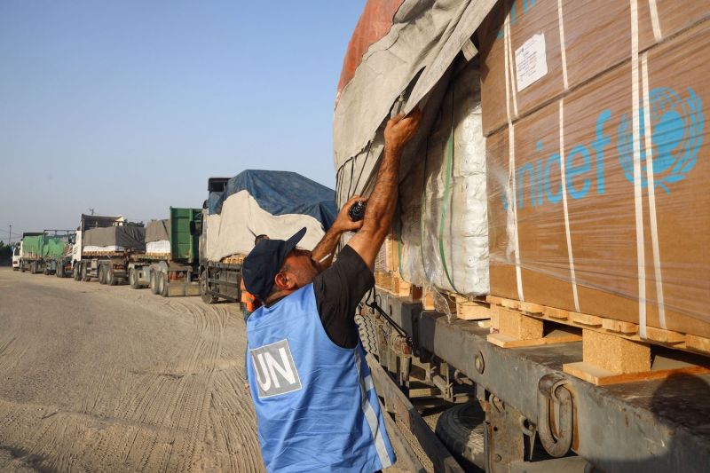 A United Nations employee checks humanitarian aid entering Gaza.