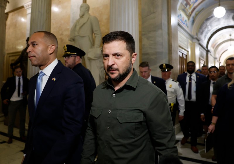 Ukrainian President Volodymyr Zelensky walks with U.S. House Minority Leader Hakeem Jeffries as he arrives for a meeting with U.S. representatives at the Capitol in Washington.