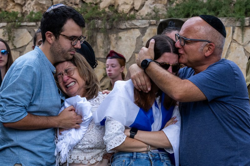 Family members of Valentin (Eli) Ghnassia, 23, who was killed by Hamas militants at Kibbutz Be’eri near the Israel-Gaza border, react during his funeral.