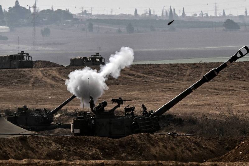 An Israeli Army M109 155mm self-propelled howitzer fires rounds toward the Gaza Strip from a position in southern Israel across the border on Oct. 28.