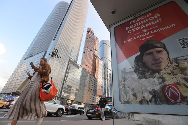 A woman walks past a building damaged in a drone attack in Moscow on Aug. 23.