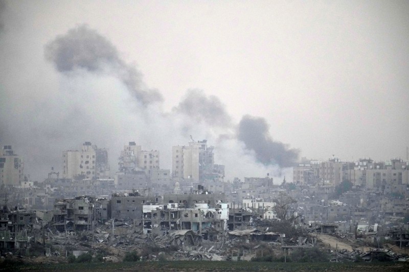 Smoke rises over northern Gaza and destroyed buildings, viewed from Sderot, Israel, on Nov. 13.