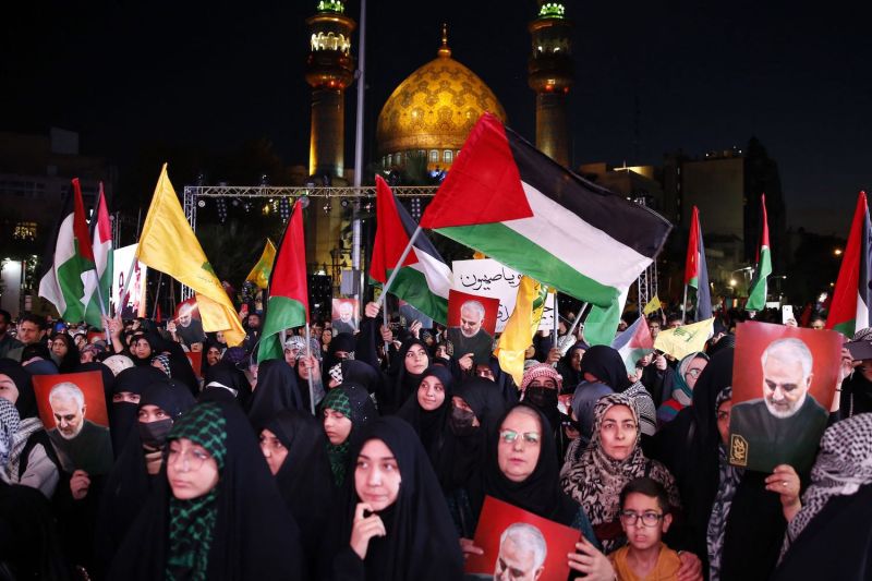 Demonstrators, mostly women, wave Palestinian and Hezbollah flags and hold posters of former Quds Force leader Qassem Suleimani during a rally in Tehran.
