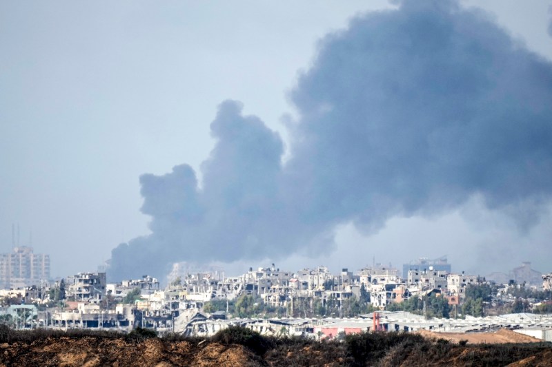 A large plume of smoke rises over Gaza City.