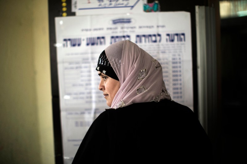 An Arab Israeli woman waits in line before voting in the northern Israeli village of Maghar.