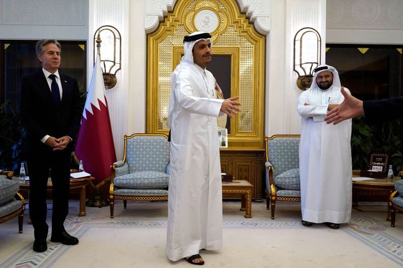 Qatar's Prime Minister and Foreign Minister Mohammed bin Abdulrahman Al Thani (C) and US Secretary of State Antony Blinken (L) attend a meeting, in Doha on Oct. 13.