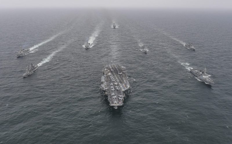 The USS Nimitz and Japan Maritime Self-Defense Force and South Korean Navy warships sail in formation during a joint naval exercise off the South Korean coast.