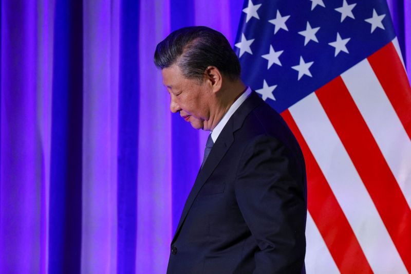 Chinese President Xi Jinping attends an event on the sidelines of the Asia-Pacific Economic Cooperation summit in San Francisco. A U.S. flag hangs in the background.