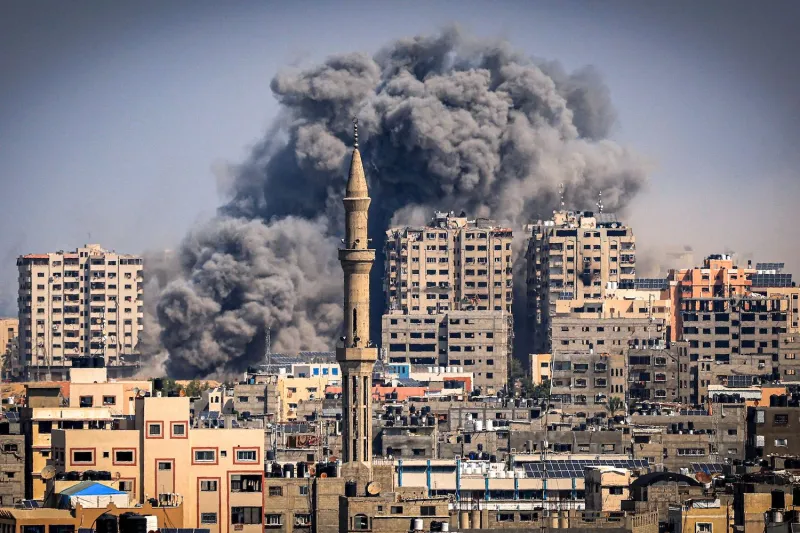 Smoke plumes billow during Israeli airstrikes in Gaza City.