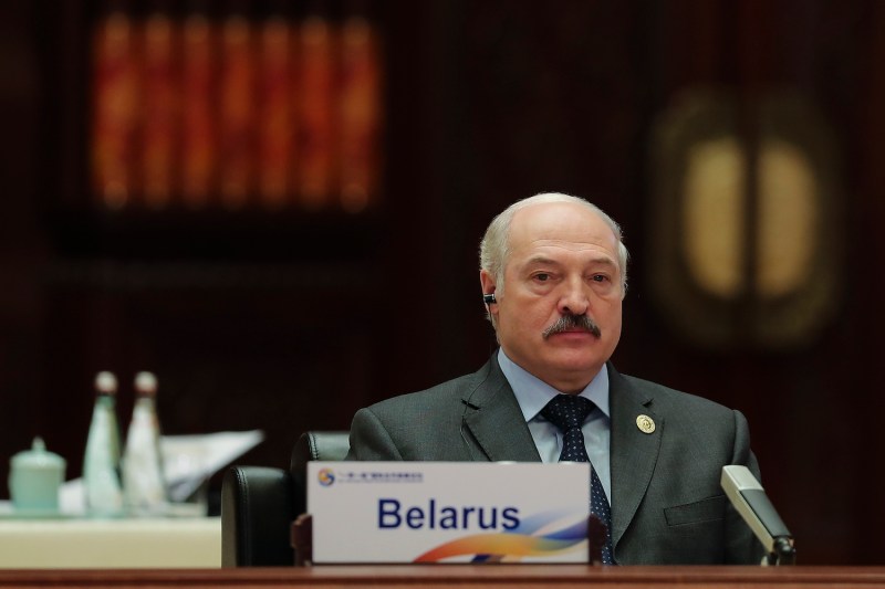 Belarusian President Aleksandr Lukashenko sits behind a placard reading "Belarus" during a meeting of the Belt and Road Forum.