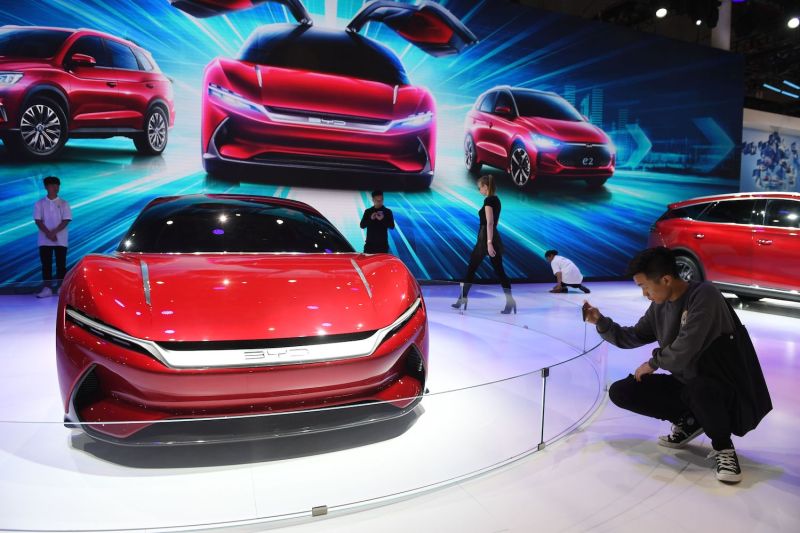 A man takes a photo of the BYD E-Seed GT electric concept car at the Shanghai Auto Show.