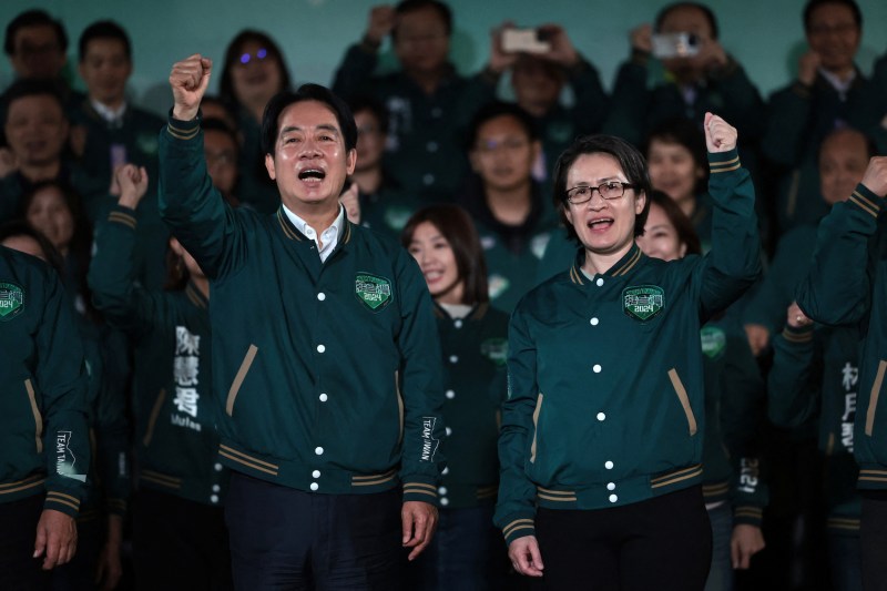Taiwan's president-elect, Lai Ching-te (L), gestures beside his running mate, Hsiao Bi-khim, during a rally outside the headquarters of the Democratic Progressive Party in Taipei after Lai won the presidential election.