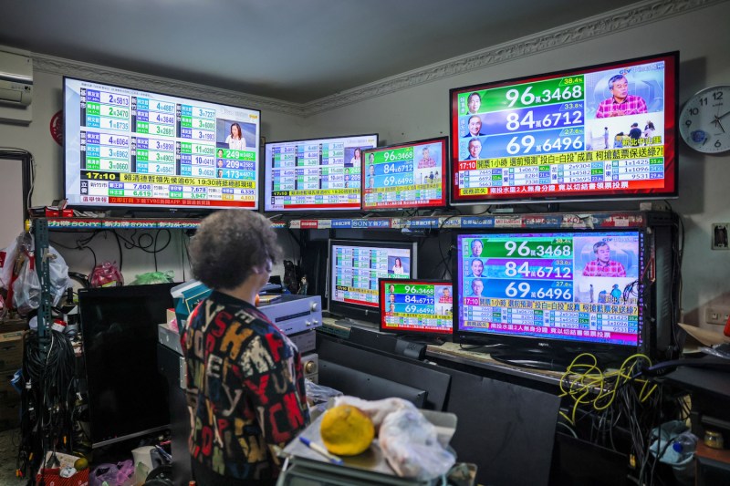 A person looks at a number of colorful screens.
