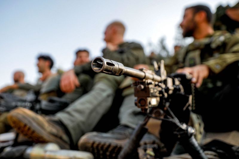 An Israeli army soldier sits by a machine gun in the upper Galilee region of northern Israel.