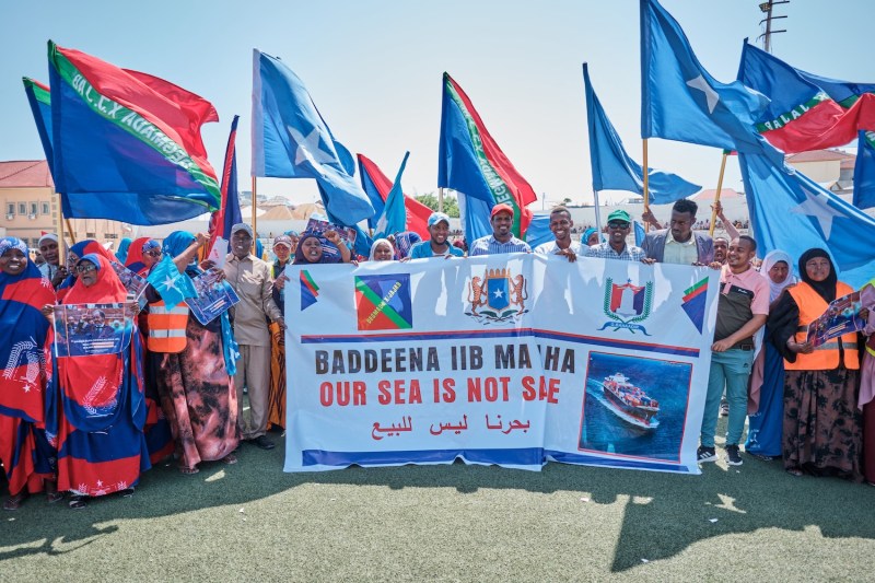 Demonstrators hold banners and flags in support of Somalia’s government following a port deal signed between Ethiopia and the breakaway region of Somaliland in Mogadishu on Jan. 3.