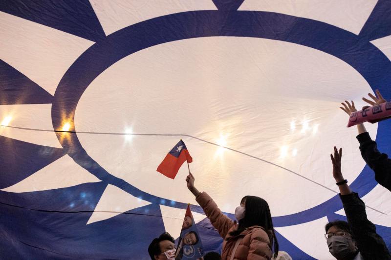 Supporters cheer under a huge flag of Taiwan during an election campaign rally of Kuomintang presidential candidate Hou Yu-ih in New Taipei City.