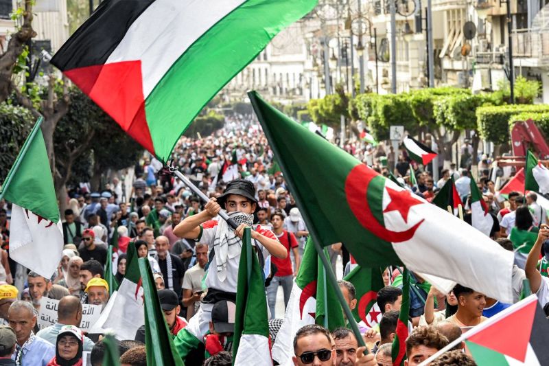Demonstrators wave Palestinian and Algerian flags as they march in a rally in solidarity with Palestinians in Algiers on Oct. 19, 2023.